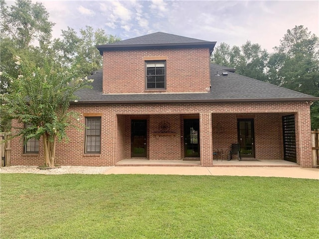 back of house with a patio area and a yard