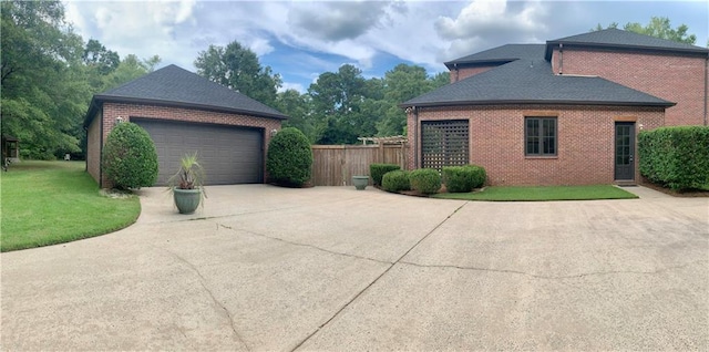 view of home's exterior with a garage and a lawn