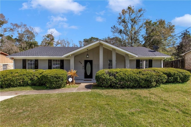 single story home featuring brick siding, a front yard, and roof with shingles