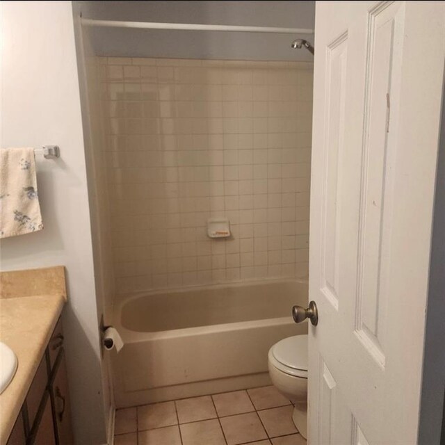 bathroom with tile patterned flooring, toilet, vanity, and tub / shower combination