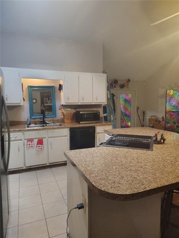kitchen featuring dishwasher, light countertops, light tile patterned flooring, and a sink