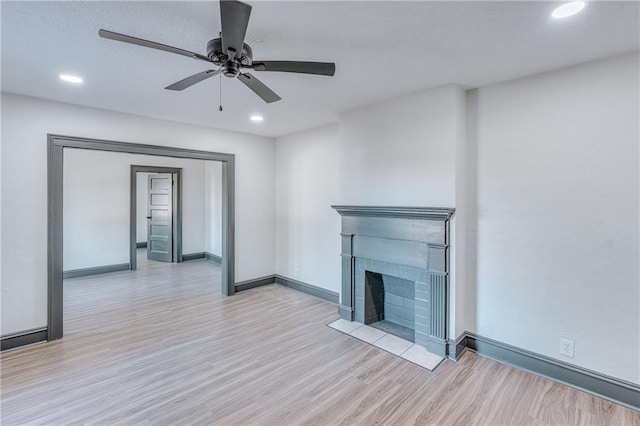 unfurnished living room with ceiling fan and light wood-type flooring