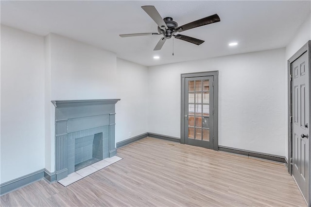 unfurnished living room featuring ceiling fan and light hardwood / wood-style floors