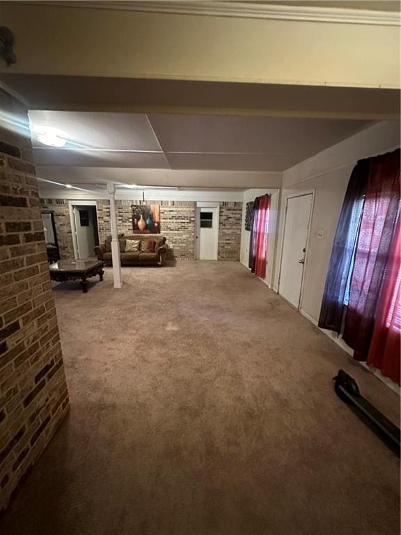 basement with carpet floors and brick wall