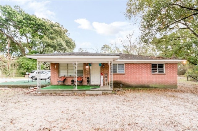 ranch-style house featuring a carport