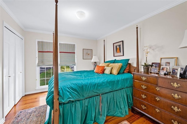 bedroom featuring a closet, hardwood / wood-style flooring, and crown molding