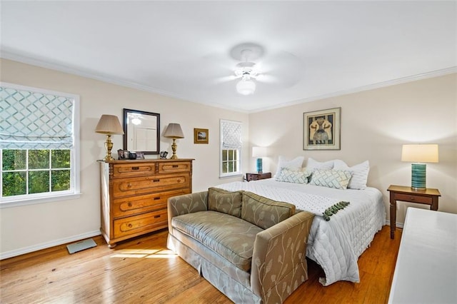 bedroom featuring ceiling fan, ornamental molding, and light hardwood / wood-style floors