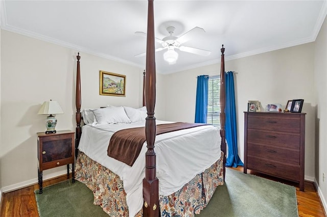 bedroom featuring crown molding, wood-type flooring, and ceiling fan