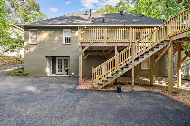 back of house with a deck, french doors, and a patio area