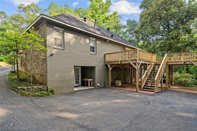 back of house featuring a deck