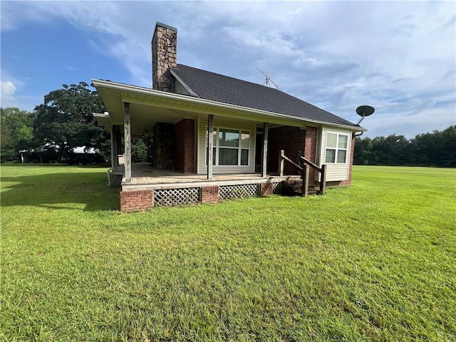 back of property featuring a porch and a yard