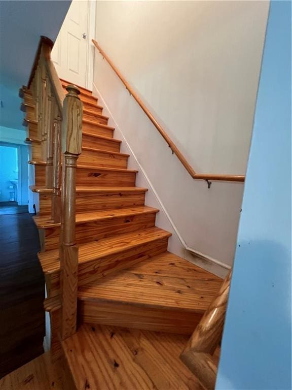 stairway featuring hardwood / wood-style flooring