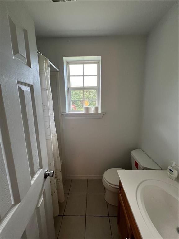 bathroom featuring a shower with curtain, vanity, tile patterned floors, and toilet