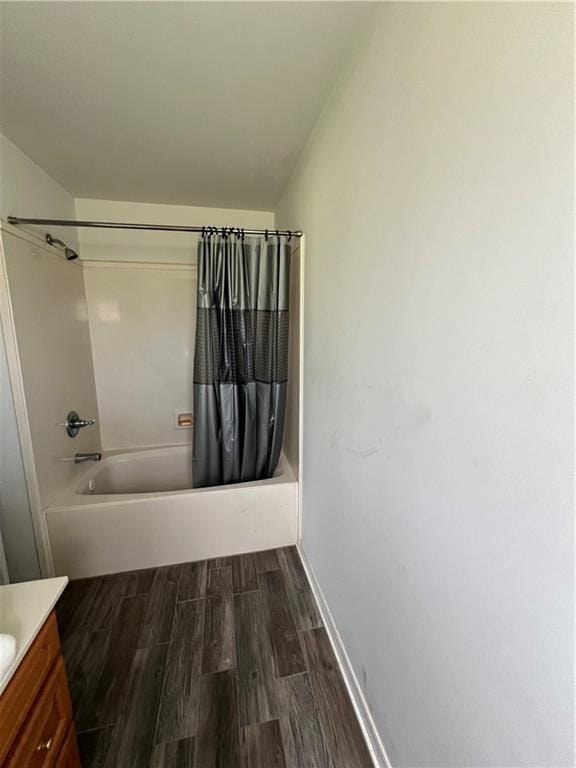 bathroom featuring vanity, hardwood / wood-style floors, and shower / bath combo with shower curtain