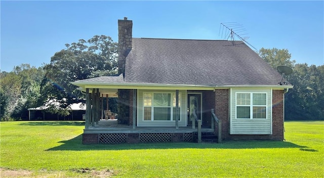 back of house featuring a porch and a lawn