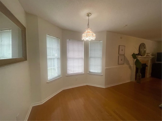 unfurnished dining area featuring hardwood / wood-style floors