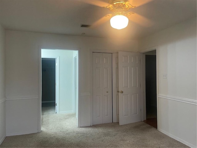 unfurnished bedroom with ceiling fan and light colored carpet