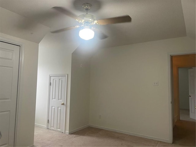 bonus room with light carpet and ceiling fan