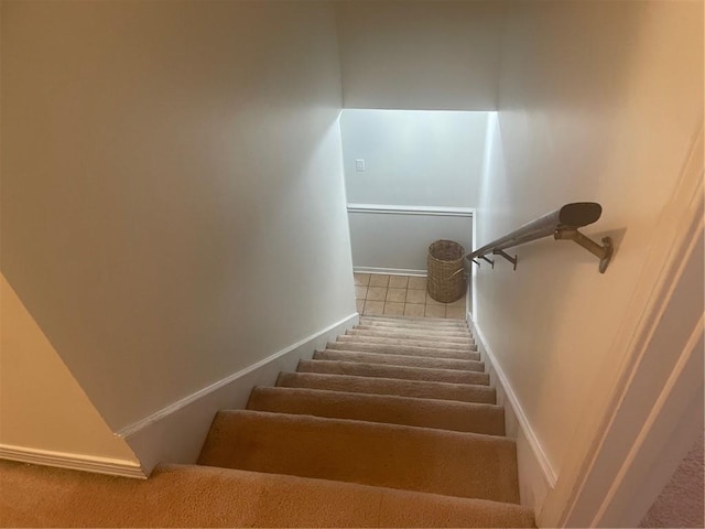 staircase featuring carpet flooring