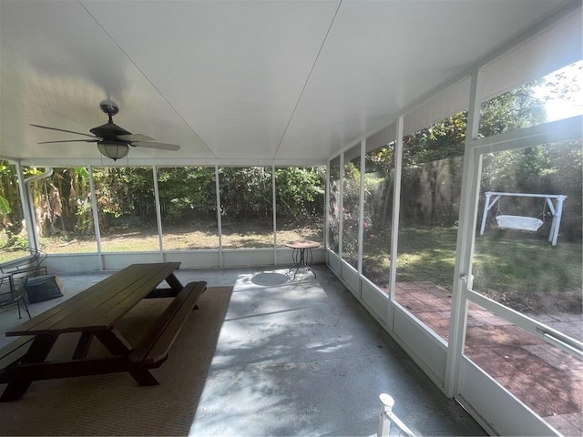 unfurnished sunroom with ceiling fan