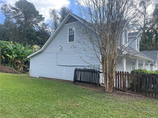 view of side of property with a lawn