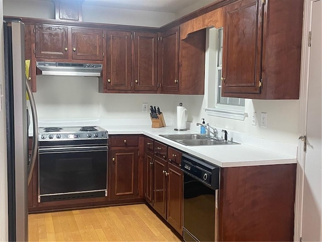 kitchen with light wood-type flooring, range with electric cooktop, stainless steel refrigerator, sink, and dishwasher