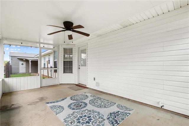 sunroom / solarium featuring ceiling fan