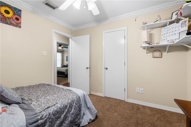 carpeted bedroom with ceiling fan and ornamental molding