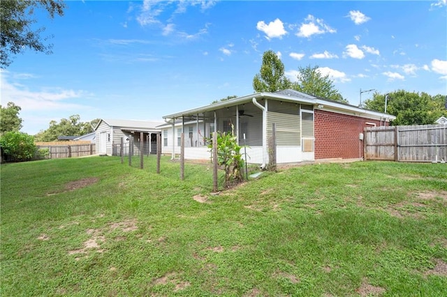 view of home's exterior featuring ceiling fan and a yard