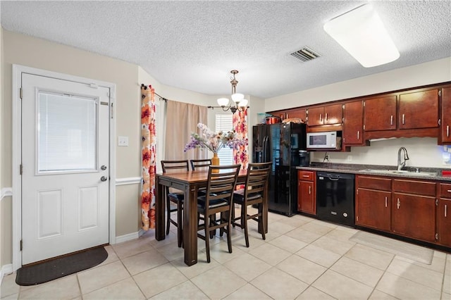 kitchen featuring sink, hanging light fixtures, an inviting chandelier, black appliances, and light tile patterned floors