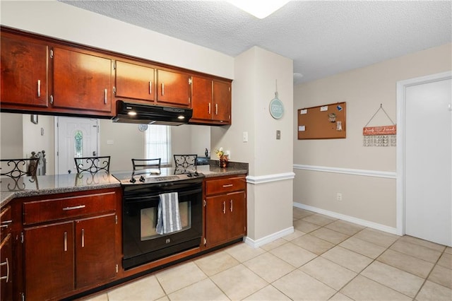 kitchen featuring a textured ceiling, electric range, and light tile patterned flooring