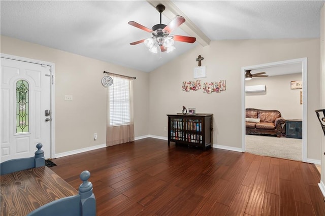 foyer with ceiling fan, a wall mounted air conditioner, lofted ceiling with beams, and dark hardwood / wood-style flooring