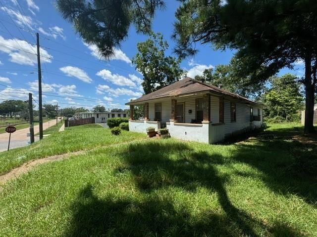 view of side of property with a yard