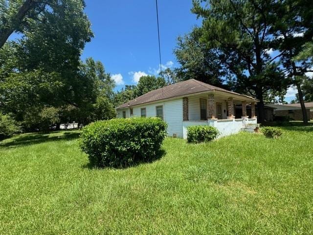 view of side of home featuring a lawn