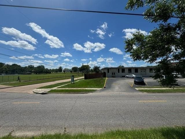 view of front of house with a front yard and fence