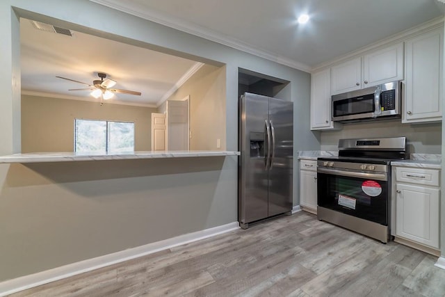 7520 Oak Dr W, Theodore, AL 36582 - kitchen with white cabinetry, crown molding, stainless steel appliances, and kitchen peninsula