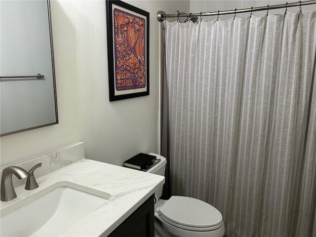 bathroom featuring vanity, toilet, and a shower with shower curtain