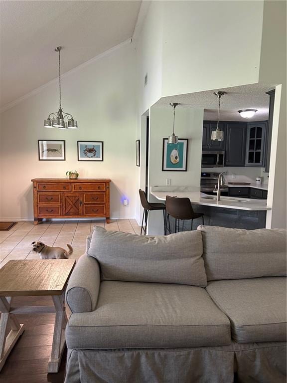 tiled living room featuring high vaulted ceiling and a notable chandelier