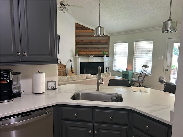 kitchen with sink, stainless steel dishwasher, a textured ceiling, a tiled fireplace, and crown molding