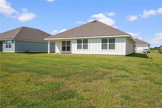 rear view of house featuring a lawn