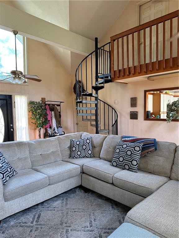 living room with ceiling fan and high vaulted ceiling