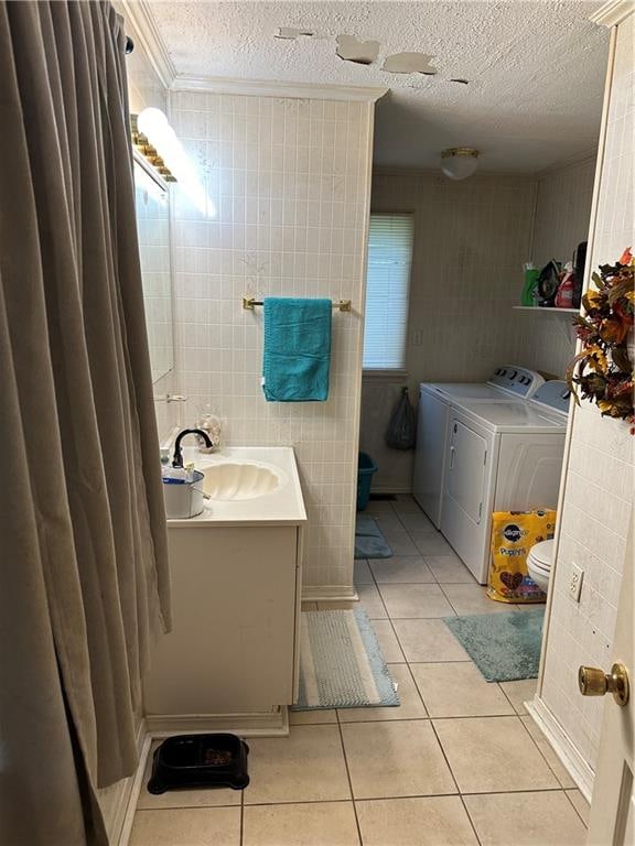 bathroom with vanity, crown molding, washing machine and dryer, tile patterned floors, and toilet