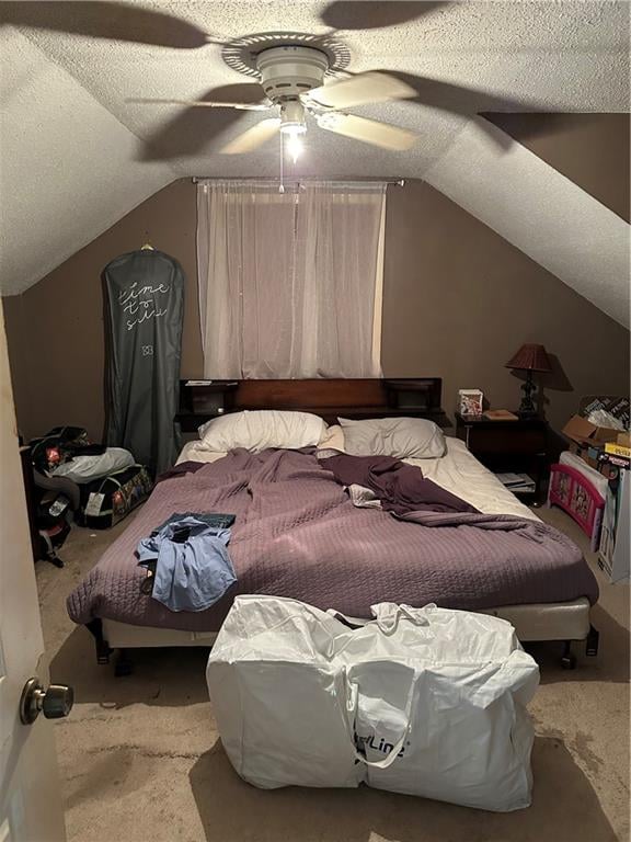 bedroom featuring ceiling fan, a textured ceiling, and lofted ceiling