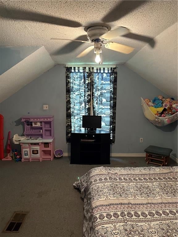 bedroom featuring a textured ceiling, carpet flooring, ceiling fan, and vaulted ceiling