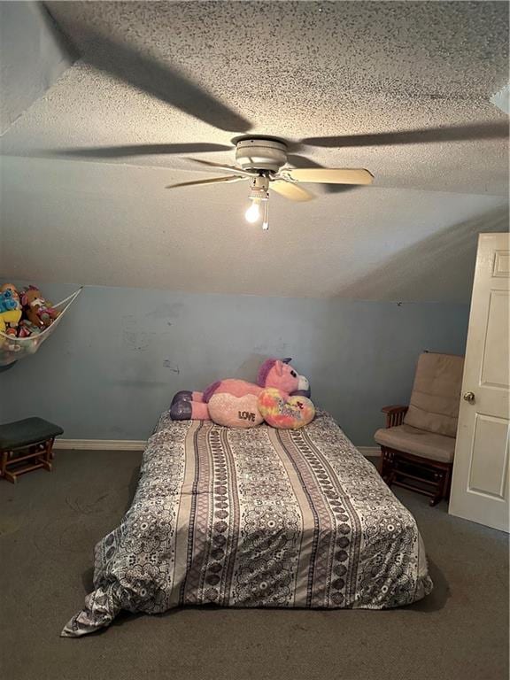 carpeted bedroom featuring a textured ceiling, ceiling fan, and lofted ceiling