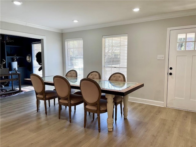 dining room with ornamental molding, light wood-type flooring, recessed lighting, and baseboards