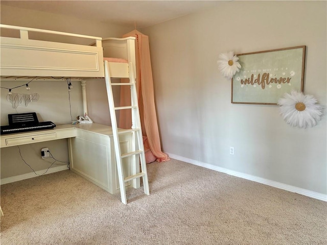 unfurnished bedroom featuring baseboards and light colored carpet