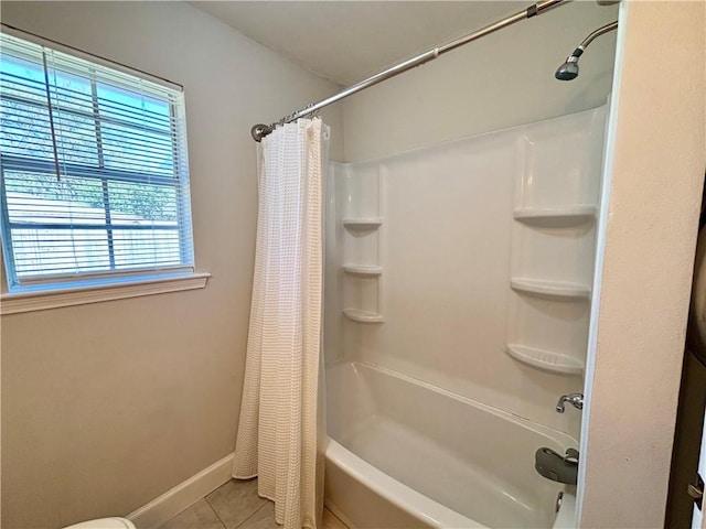 bathroom with baseboards, shower / bathtub combination with curtain, and tile patterned floors