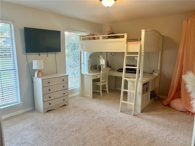 bedroom with carpet flooring and baseboards