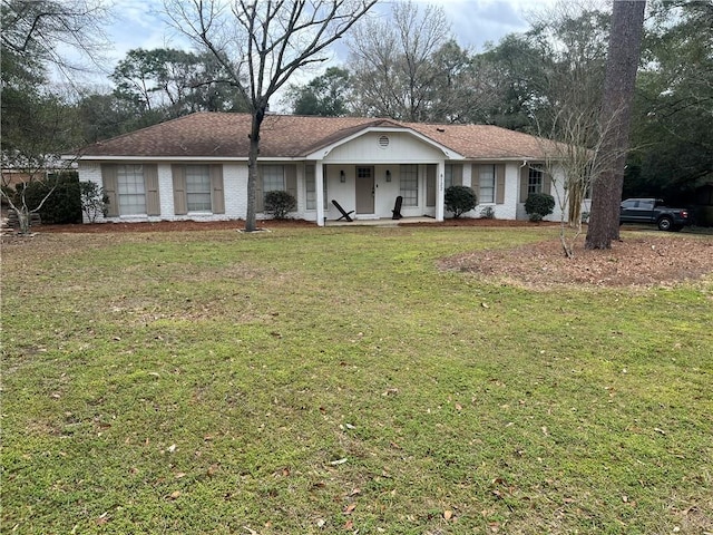 ranch-style home featuring a porch, brick siding, and a front lawn